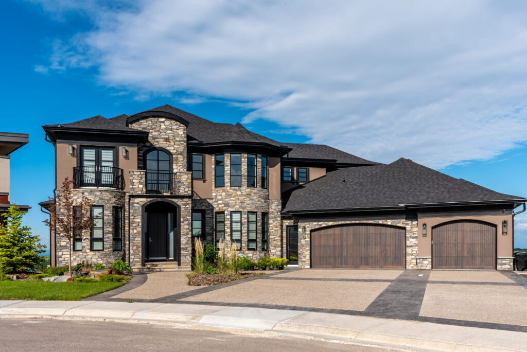 Custom built luxury home in Ontario featuring stone exterior, triple garage, and professional landscaping