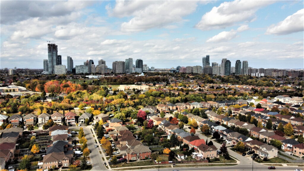 Aerial view of Mississauga Ontario residential neighbourhood with single-storey 
homes and city skyline, highlighting demand for second storey additions in urban areas