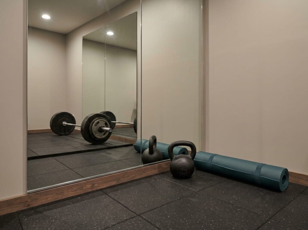 Home gym renovation with rubber flooring and gym wall mirrors