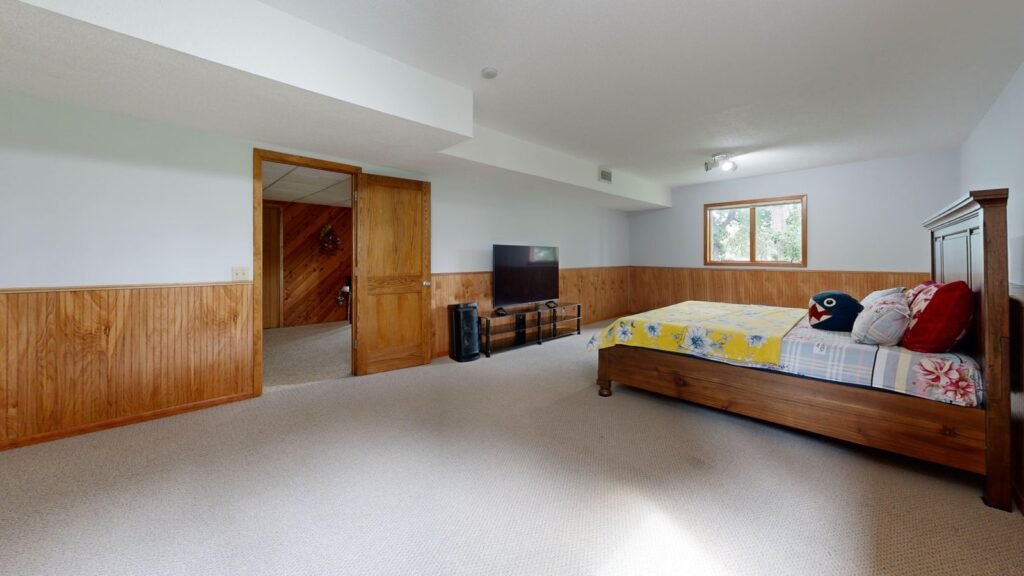 Finished basement bedroom with wood accents