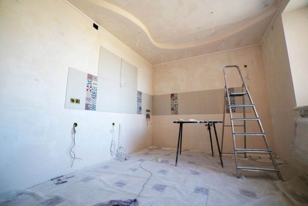 Room under renovation with new tile, paint and tools