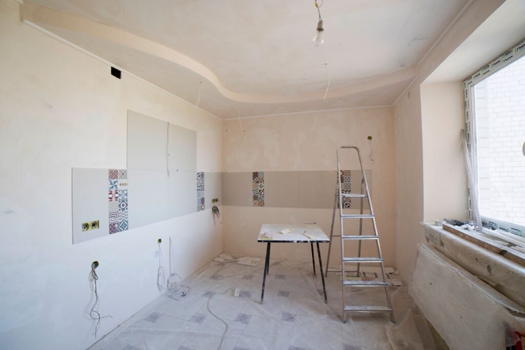 Kitchen under renovation with ladder and tools