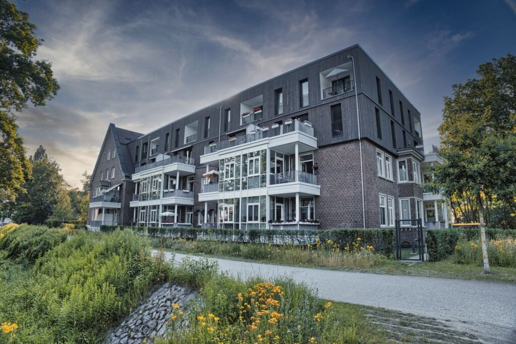 Modern multi-unit residential building surrounded by greenery