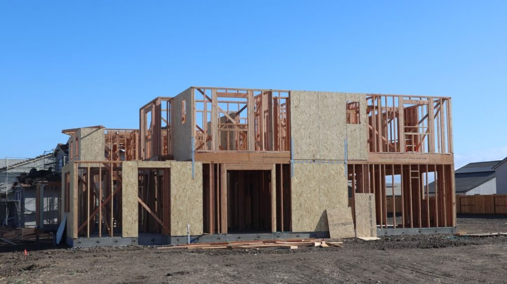 Wood-framed house under construction, the stage where a Brampton building permit and framing inspection apply