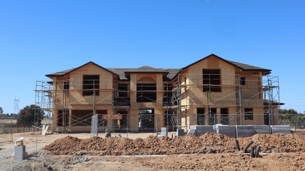New two-storey custom home under construction with scaffolding