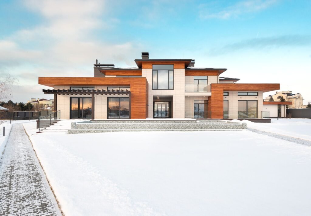 Modern compact house with large windows and wood cladding