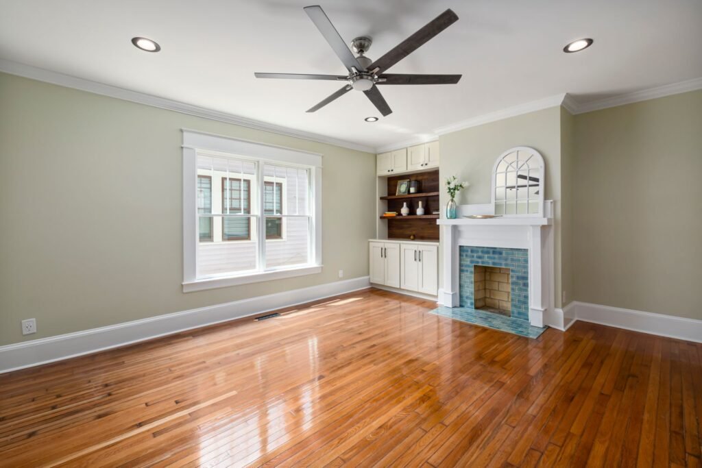 Spacious renovated living room with hardwood floors and fireplace